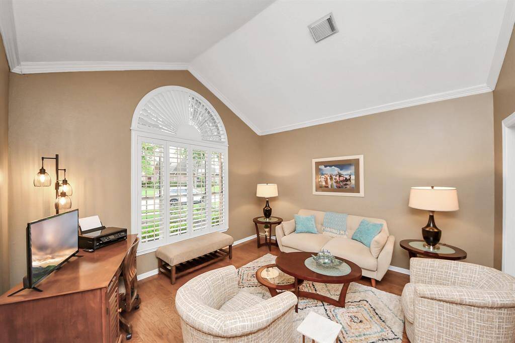 The formal living space offers versatility to suit your needs—ideal as a home office, study, or library.