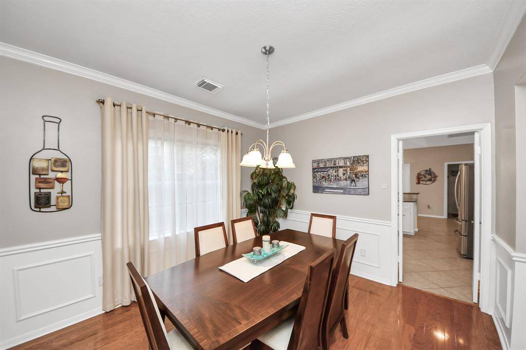 The formal dining room features distinctive wainscoting that elevates the space, creating a beautifully refined setting for gatherings.