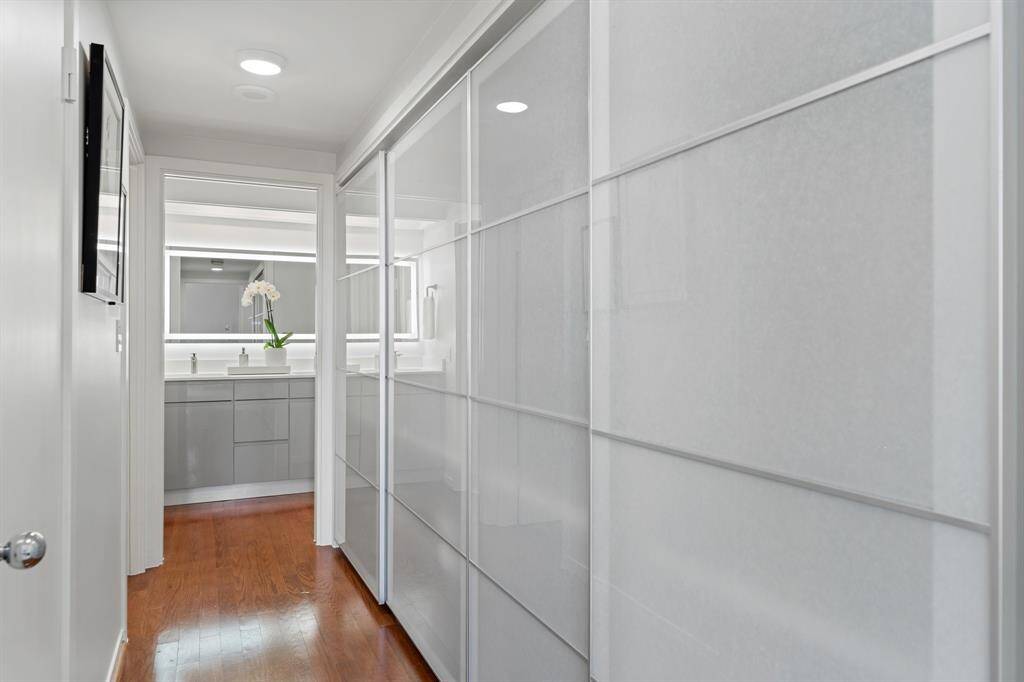 Custom sleek design closet doors leading to the bathroom