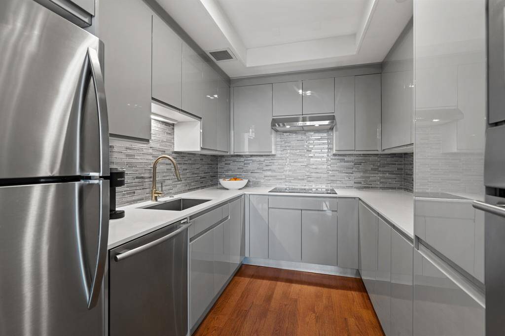 Custom lacquered cabinetry, Quartz counter tops and stainless steel appliances.