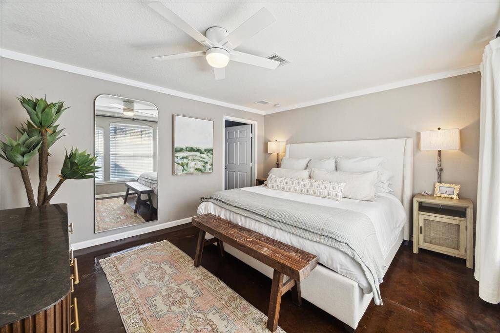 A serene primary bedroom with abundant natural light and a peaceful ambiance.  The door leads to the primary bath and closet