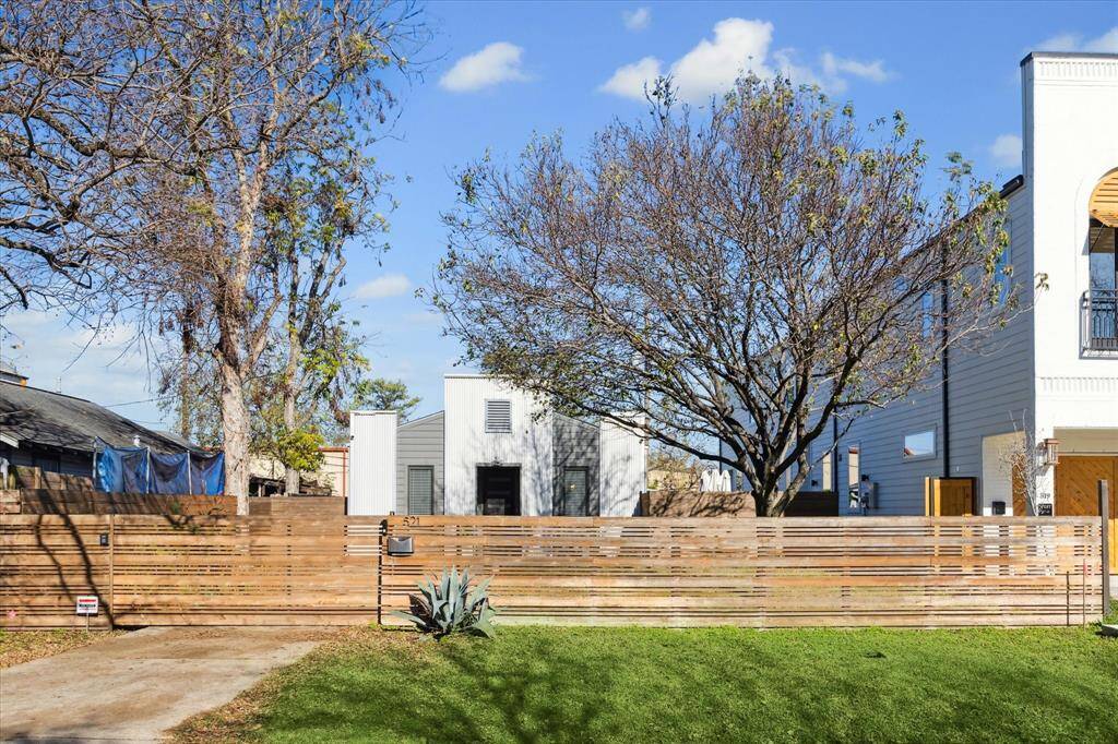 A modern wood gate with electronic gate opener provides privacy and security!