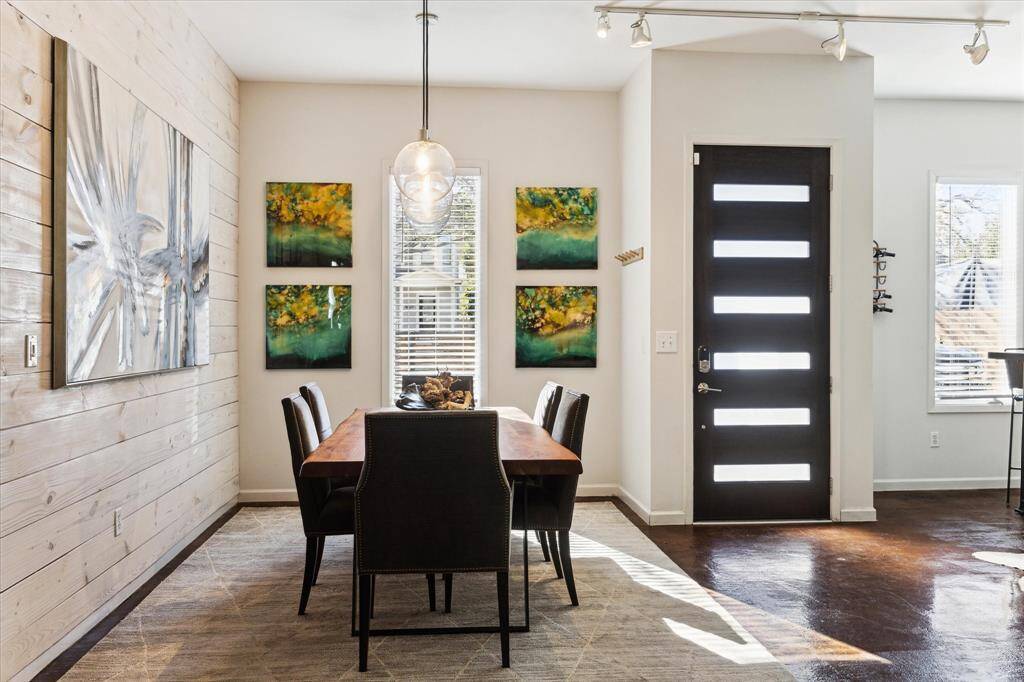 Bright dining area with shiplap accent wall.