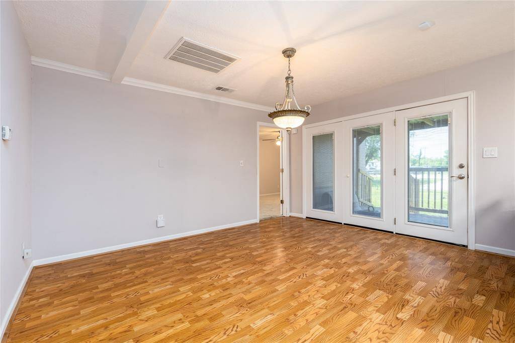 Dinning room has laminate wood flooring and recent light fixture.