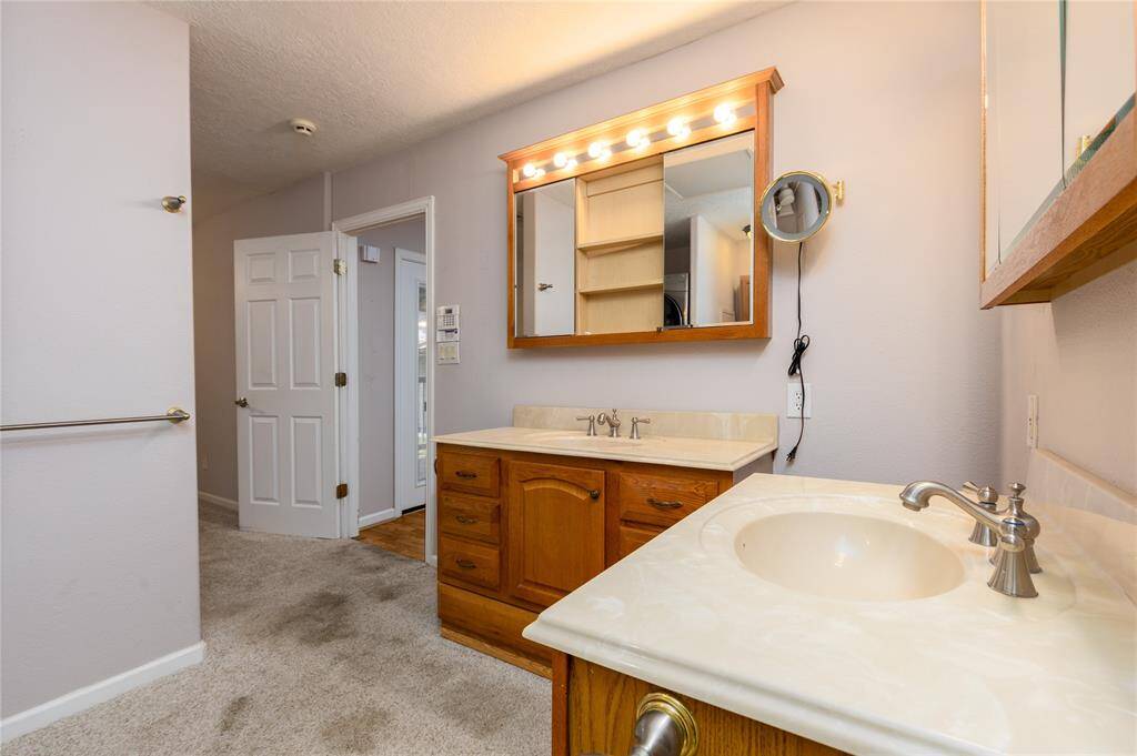 Main Bathroom has his and hers sinks and cabinets.