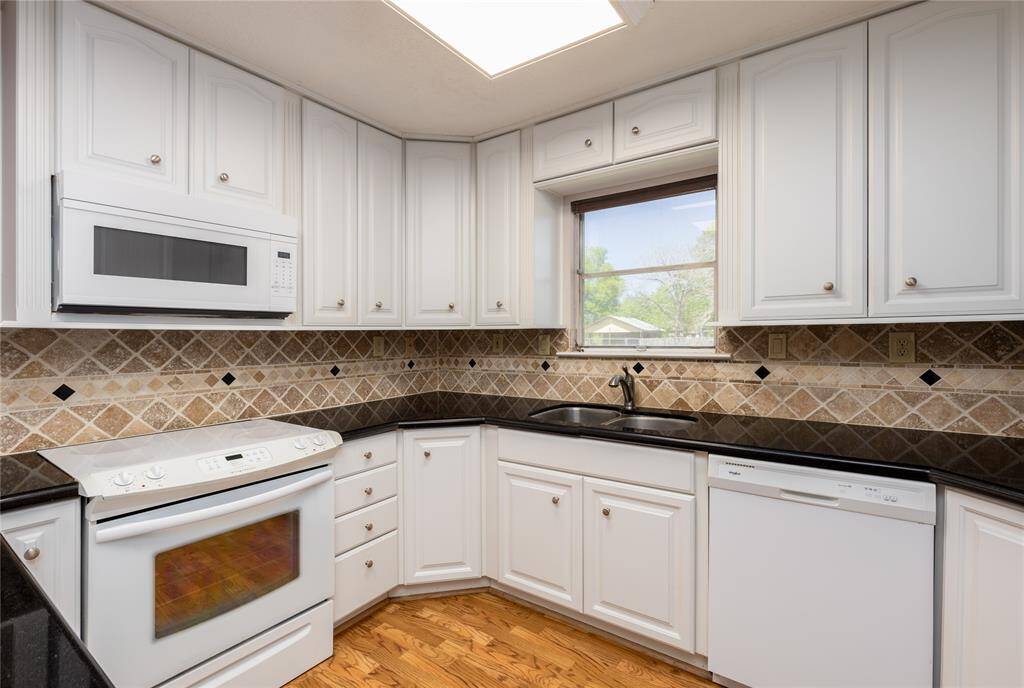 Kitchen has been updates with new cabinets, tile back splash and Granite counter tops.