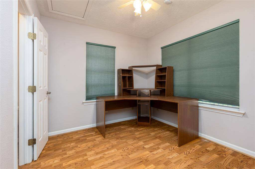 2 Bedroom is being used for a office with laminate flooring.