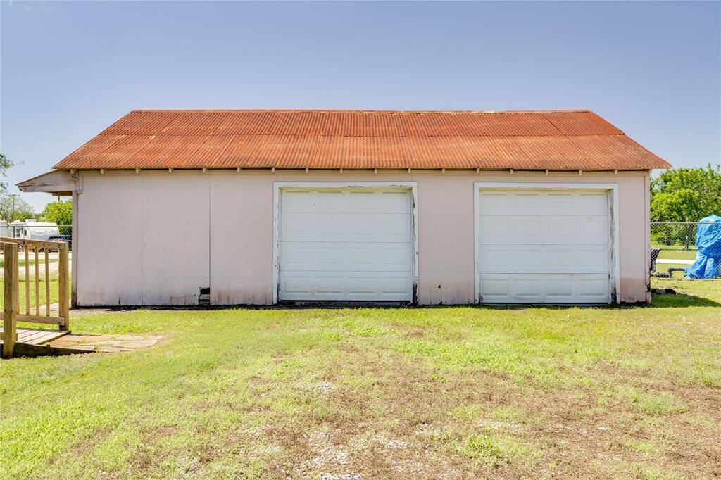 Two car garage also has two extra rooms that can be used for storage and a workshop ..