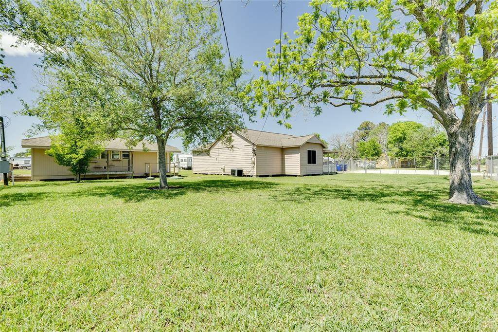 Nice side yard with great shade trees and has a building that can be used for extra storage ..