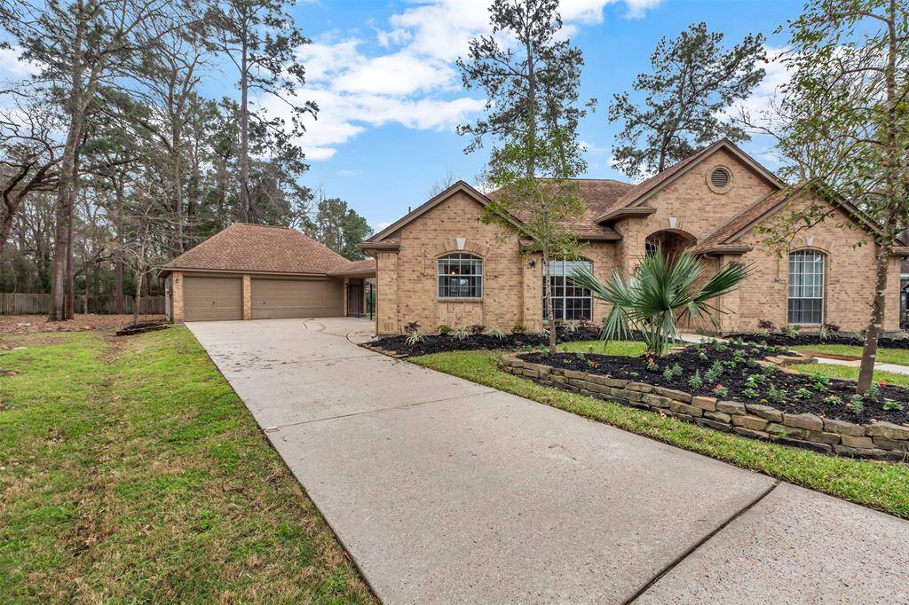 This charming single-story brick home features a spacious driveway leading to a detached two-car garage. The well-maintained front yard includes a landscaped garden with trees and shrubs, offering a welcoming curb appeal.
