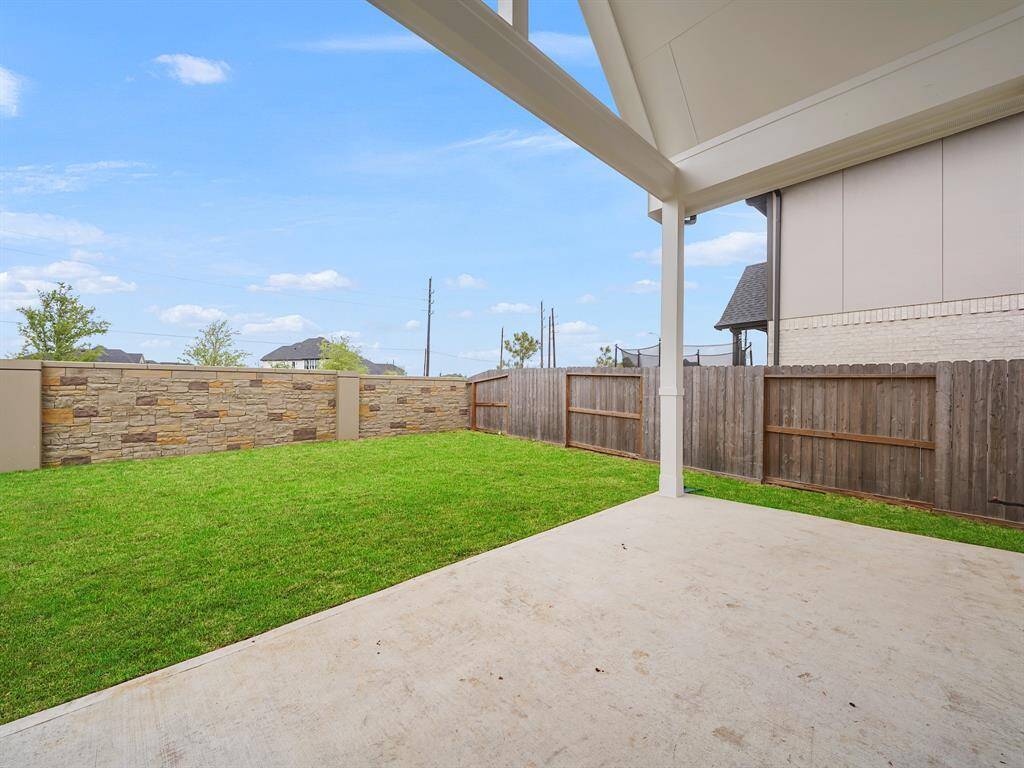 magine yourself unwinding after a long day on this property's amazing covered back porch. Offering protection from the elements, it's the ideal space for al fresco dining, enjoying your morning coffee, or simply relaxing in the tranquility of your backyard.