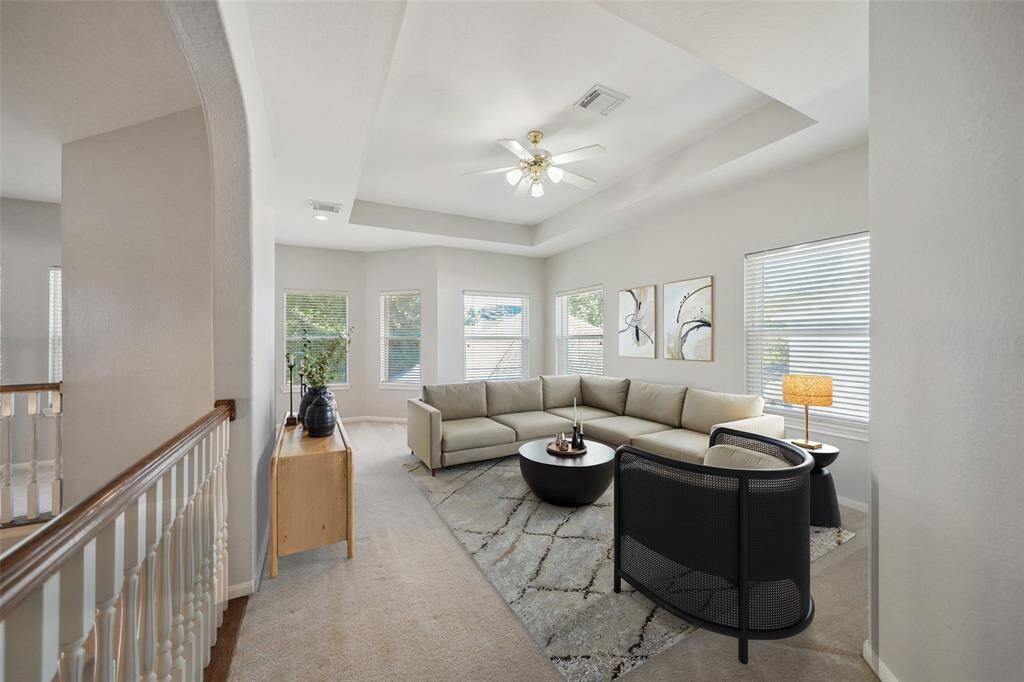 The unique upstairs has many different common areas including a game room, study area and Juliet balconies.  Digitally staged.