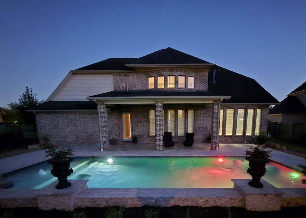 Back of home with pool