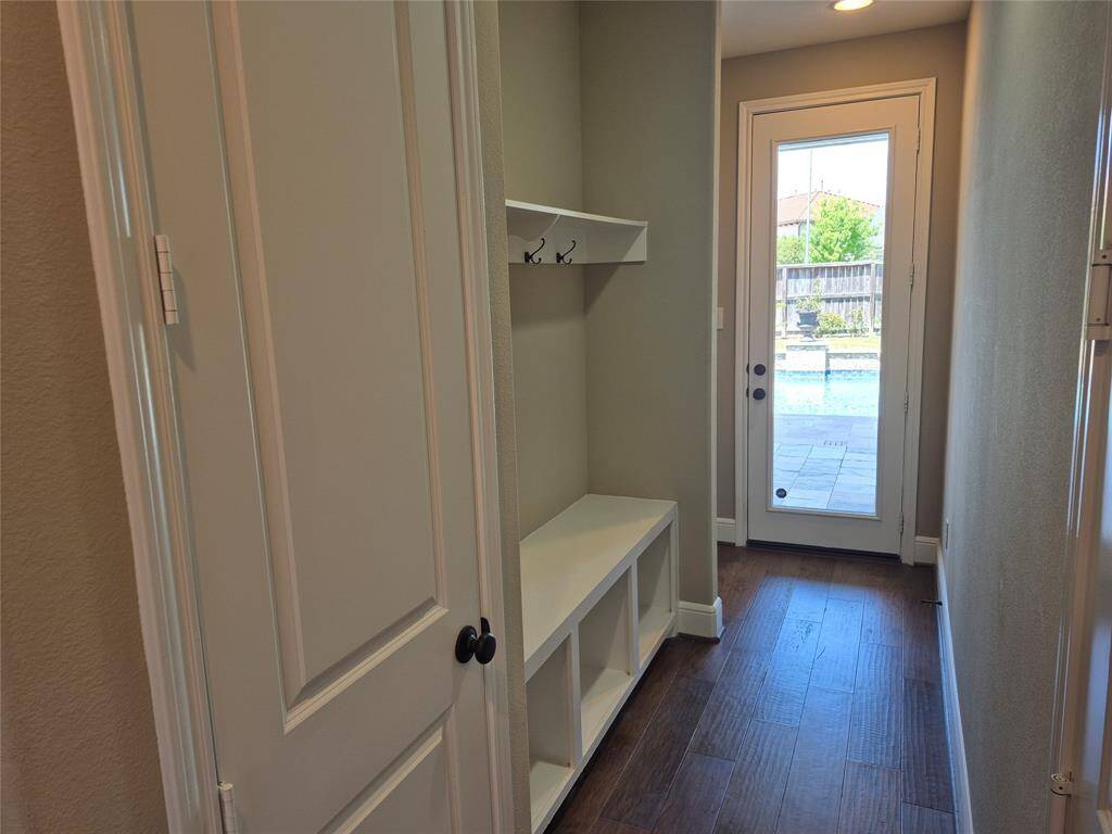 Mud Room. This room sits between the large garage and the living room. PERFECT for coming in from the pool! Closet, coat hooks, and storage nooks.