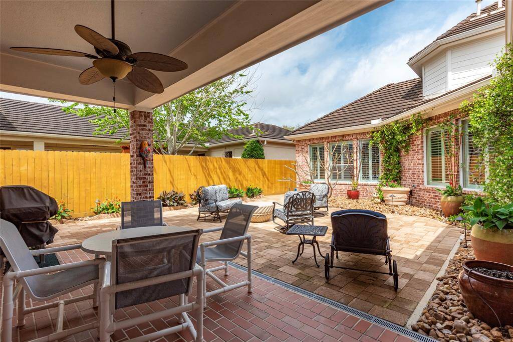 Backyard patio provides gated private walkway to the driveway and garage; storage shed for gardening tools too.  Recent 7-foot fence.