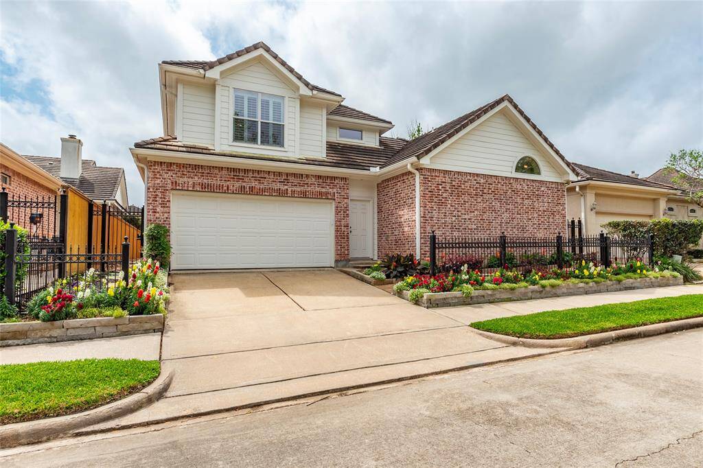 Lush professional landscaping surrounding the fenced property. Attached full 2-car garage with direct access to the gated patio and side yard.
