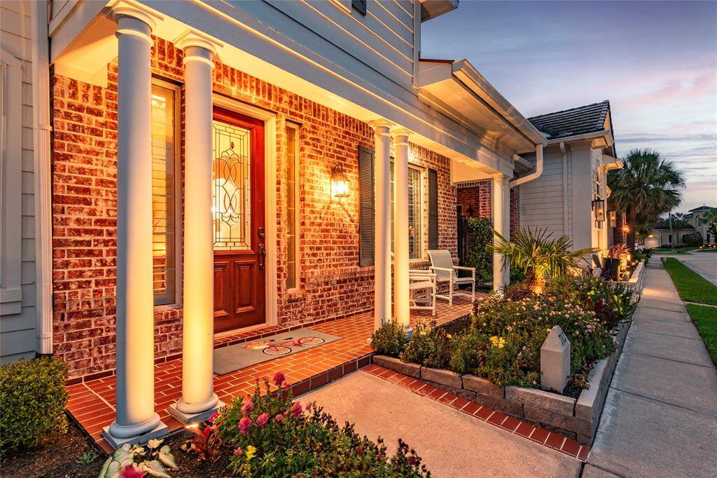 Well-lit porch features beautifully landscaped gardens. Recent exterior paint and concrete tile roof.