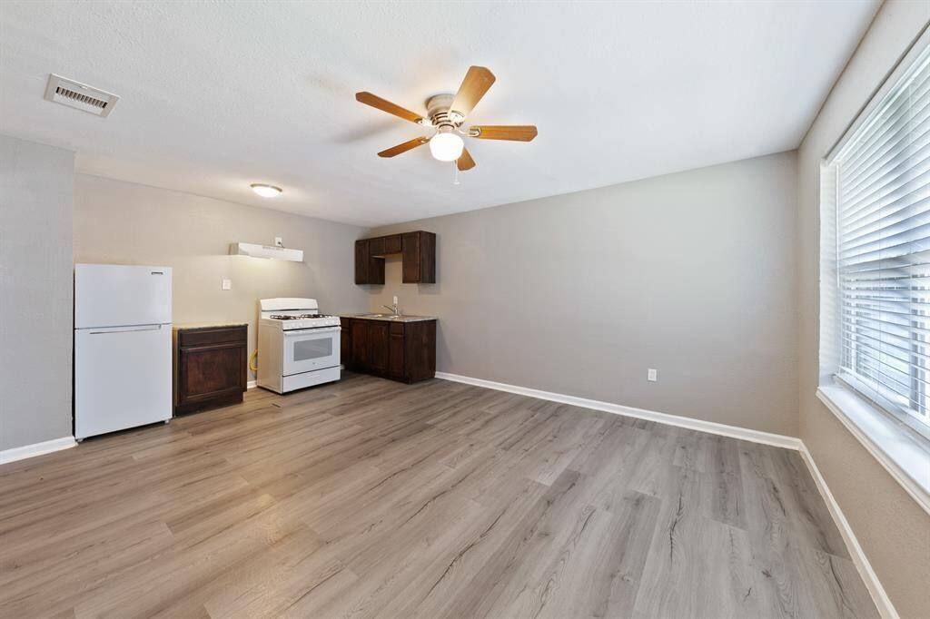 Stylish laminate hardwood floors, stainless steel appliances, updated cabinetry, and a spacious open layout.