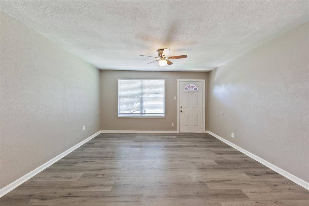 This fourplex features a large living area at the front of each unit, complete with stylish laminate hardwood floors and abundant natural light.