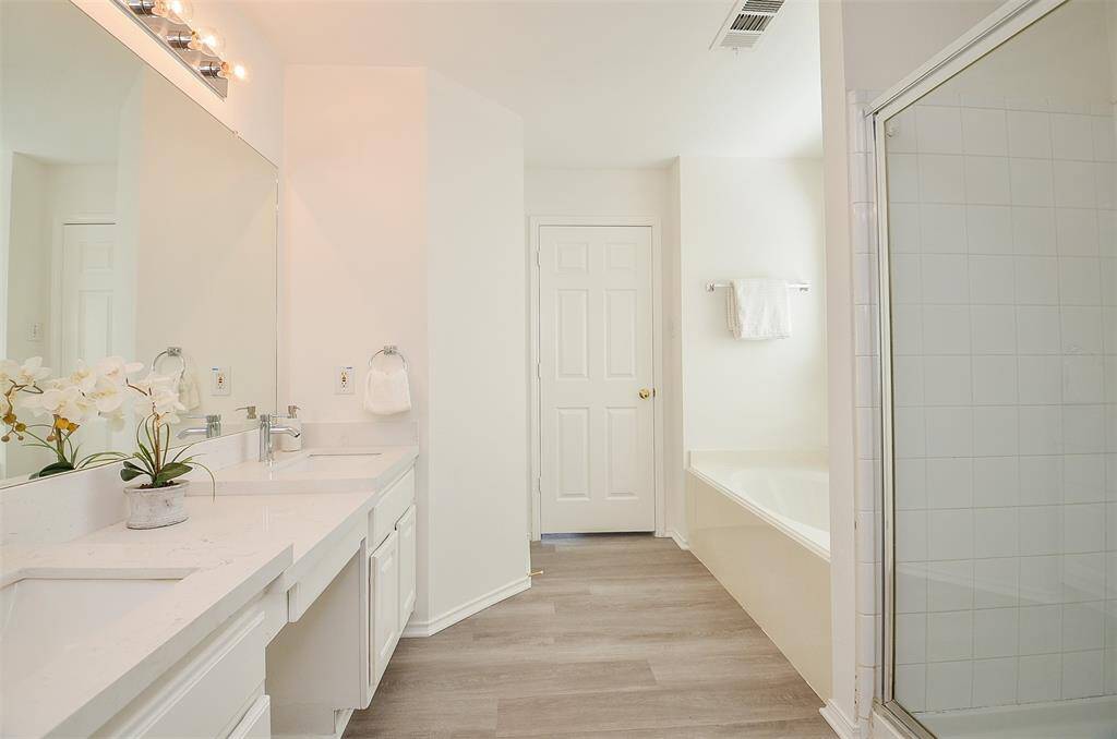 Primary bathroom with separate tub and shower.