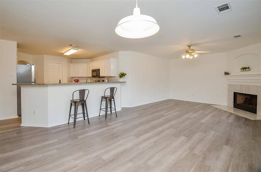 View of the open plan living to the kitchen showing the eat-up bar.