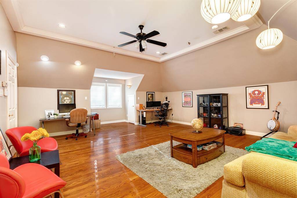 Upstairs game room with gleaming wood floors.  This room has a door to keep the noise down while all the fun is happening!