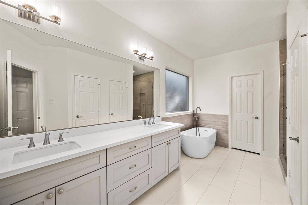 Large primary bathroom with soaker tub and separate shower
