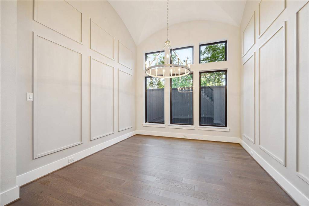 A sure to impress formal dining area with statement lighting and arched spiral staircase.