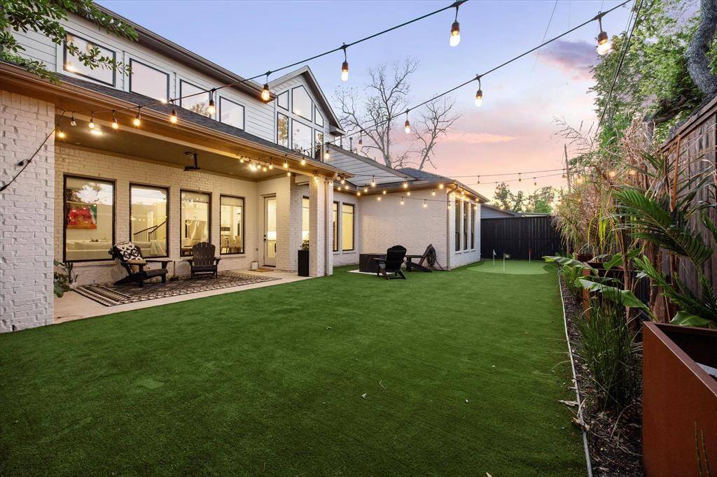 View of spacious turfed yard perfect for pets, kids play and hosting.
