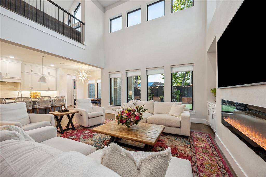 You'll find gleaming engineered hardwood floors throughout, soaring 21 ft ceilings, plethora of built ins, fireplace and more!