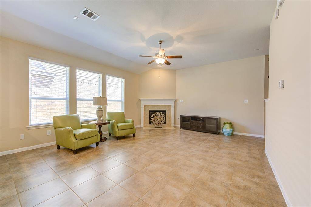 This beautiful, comfortable living room also has a cozy fireplace in the corner and plenty of natural light.