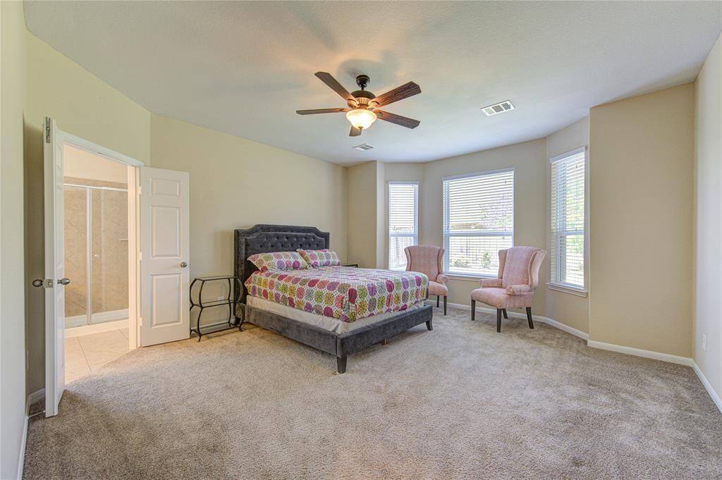 Spacious primary bedroom with a beautiful bay window.