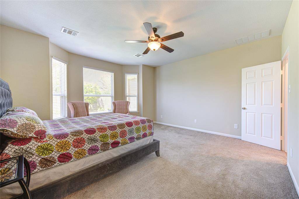 Another view of this spacious primary bedroom.
