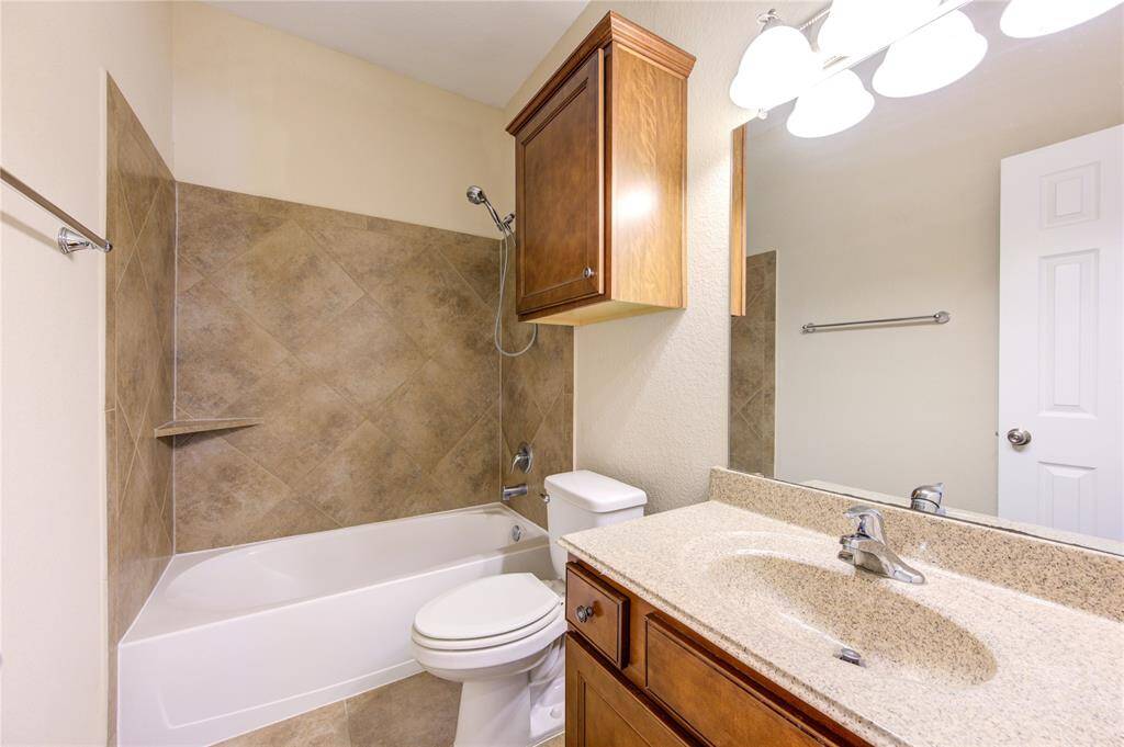 Secondary bathroom has tub/shower combo and extra storage cabinet.