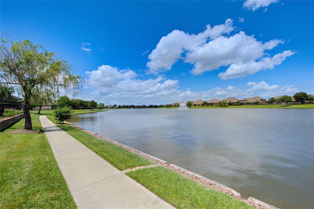 Subdivision lake with walking trail.