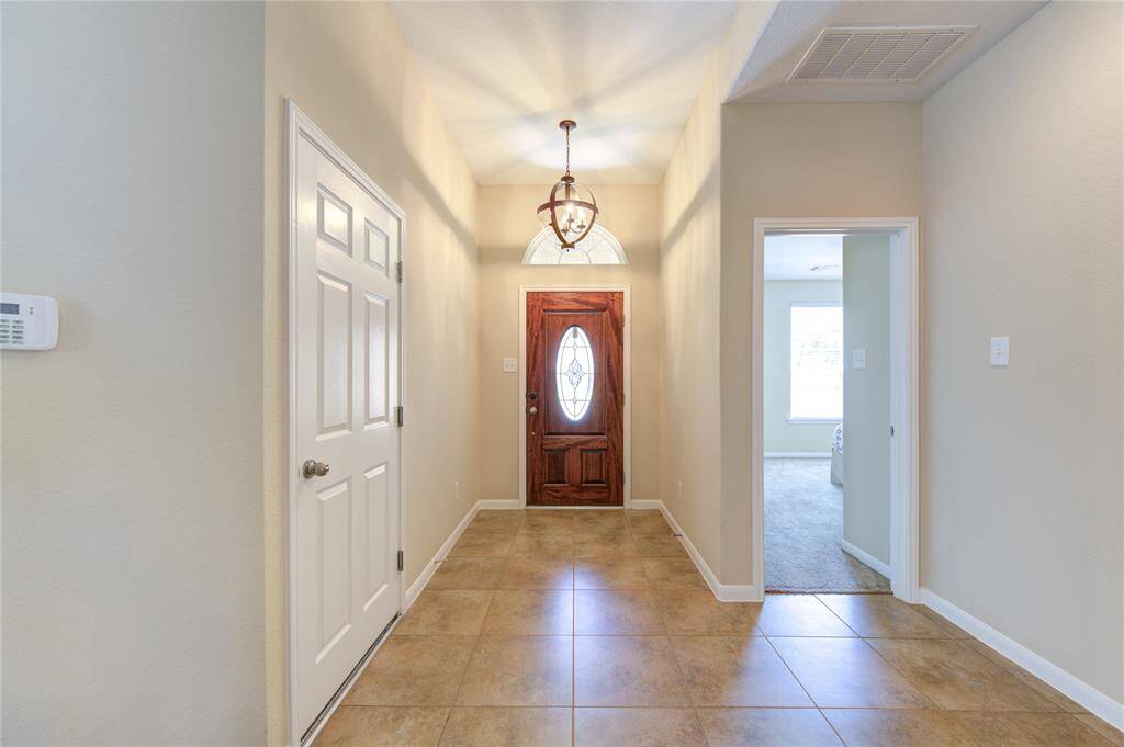 Welcoming foyer with tall ceilings.