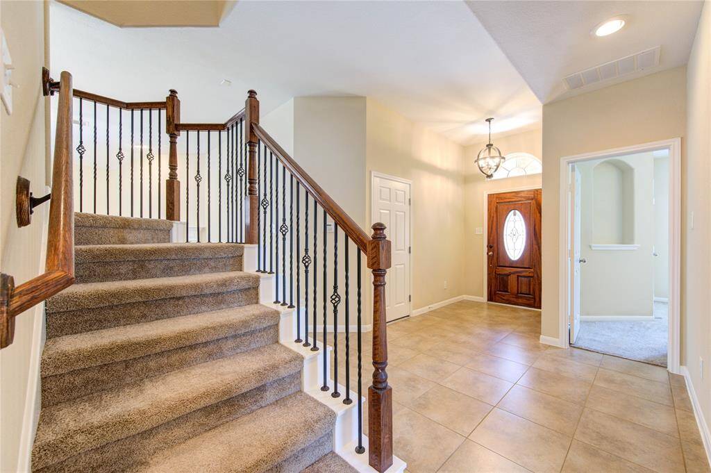 Foyer is very spacious. The garage door is to the right of the entry door.