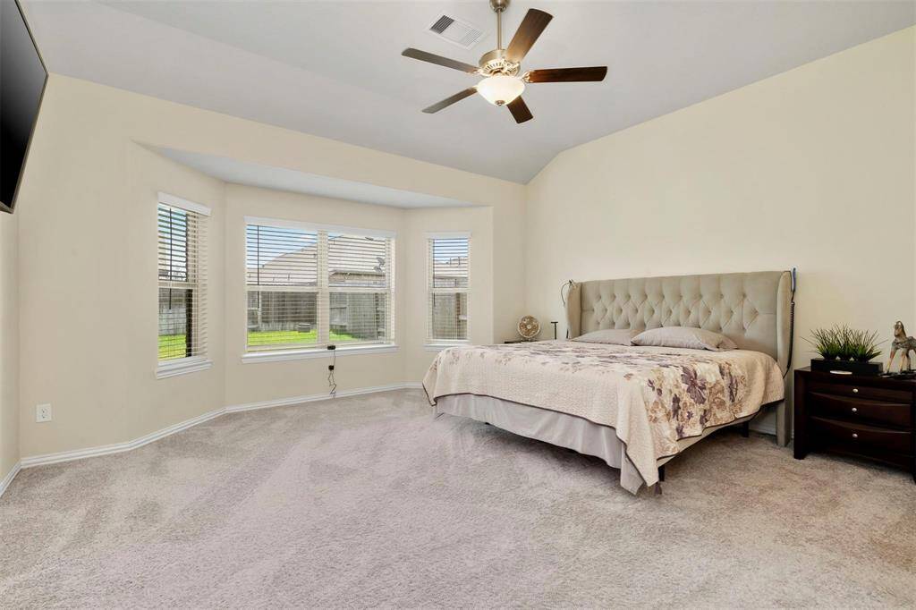 Spacious primary with bay windows.