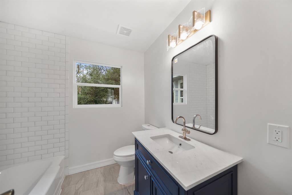 The secondary bathroom includes tile floors, and granite countertops.