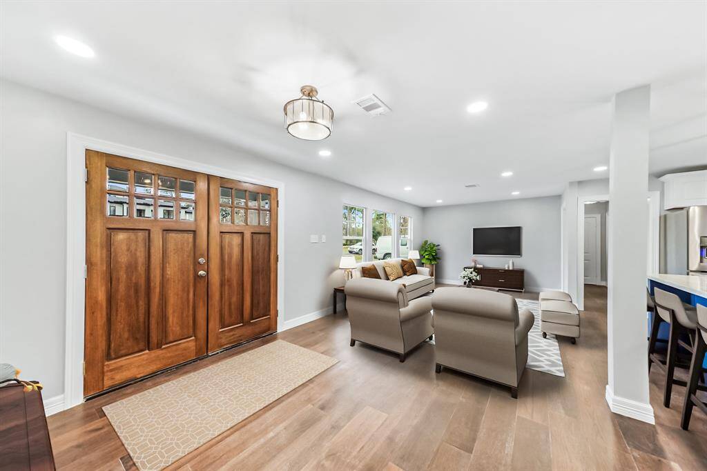 Virtually Staged: This stunning living room features engineered wood floors, and recessed lighting.