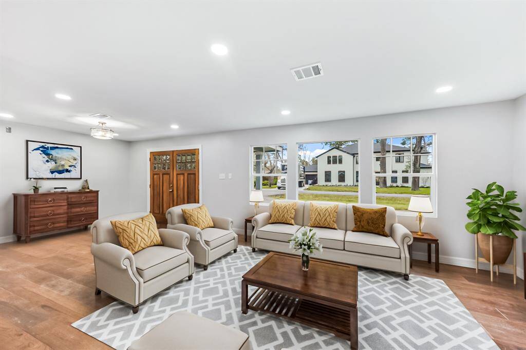 Virtually Staged: This home will greet you with beautiful natural lighting,engineered wood floors, and a fantastic view of the front yard.