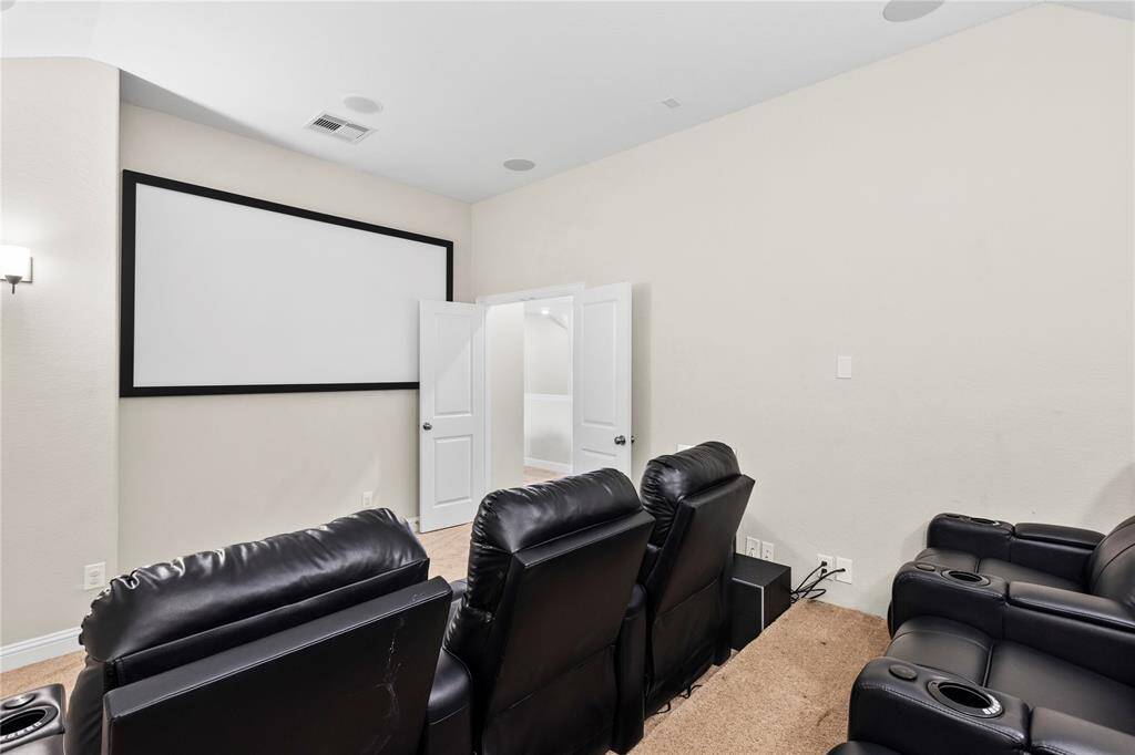 The home includes a private movie theater, perfect for an immersive cinematic experience.