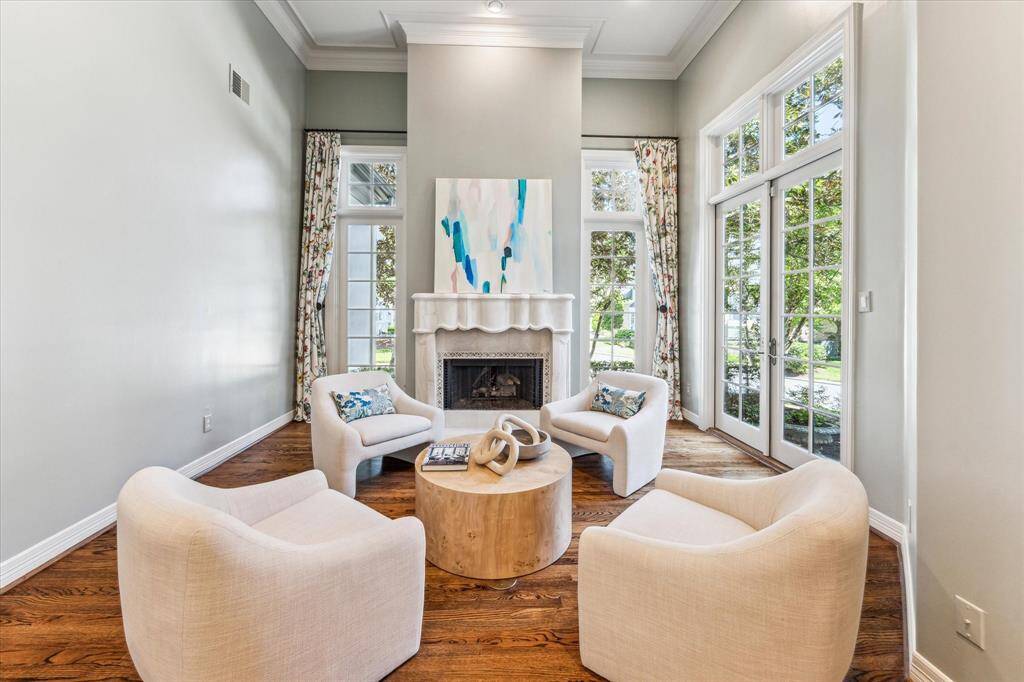 Perfectly situated off the kitchen, this secondary living space offers a cozy and casual gathering area. The den features a warm gas log fireplace and provides lovely views of the charming outdoor space, making it an inviting spot for relaxation and enjoyment.