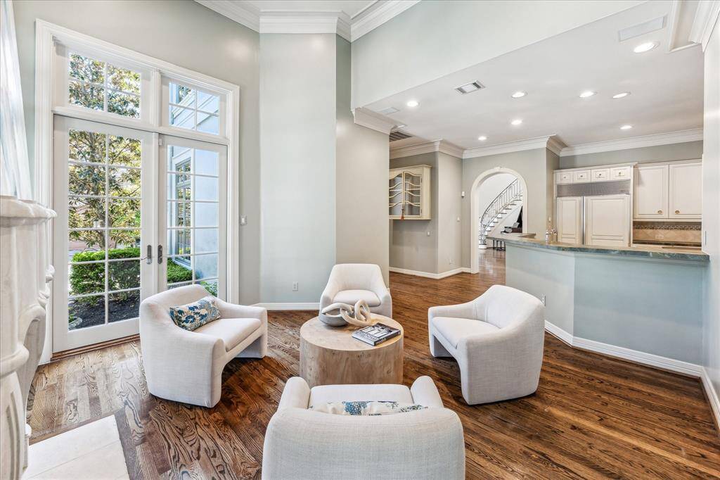 Charming view of the den, highlighting its inviting atmosphere and the seamless flow into the kitchen.