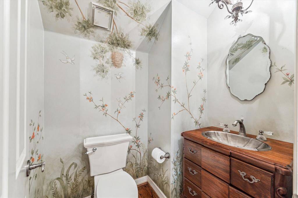 Styled with designer trends in mind, this elegant half bath, conveniently located off the living room, offers guests a private and sophisticated space. Its thoughtful design ensures both comfort and style, making it a welcoming addition to your home.