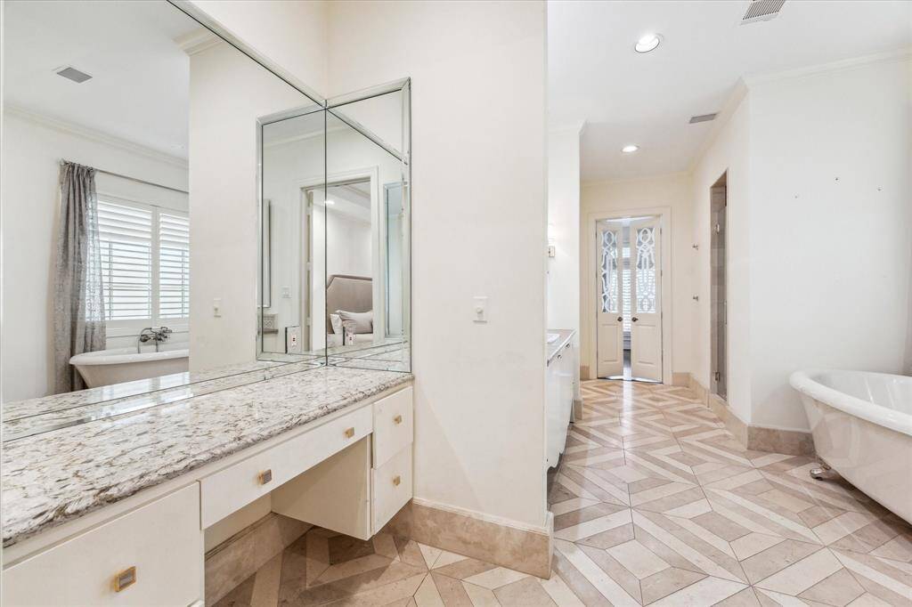 The primary bath offers a luxurious, spa-like retreat with its elegant vanity, double sinks, and stand-alone tub. The spacious walk-in shower provides a refreshing experience, while the water closet ensures privacy. Additionally, the massive walk-in closet offers ample storage, making this inviting space perfect for ultimate comfort and relaxation.