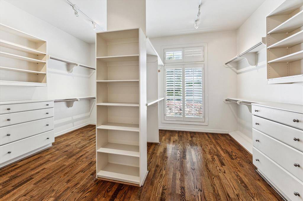 The incredible, large walk-in closet features abundant storage, plenty of shelves, and ample hanging rods, providing an organized and spacious solution for all your wardrobe needs.