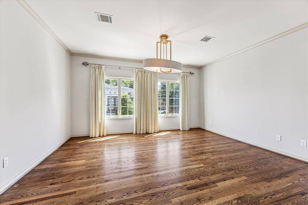 One of the secondary bedrooms up features gleaming hardwoods and en suite full bath.