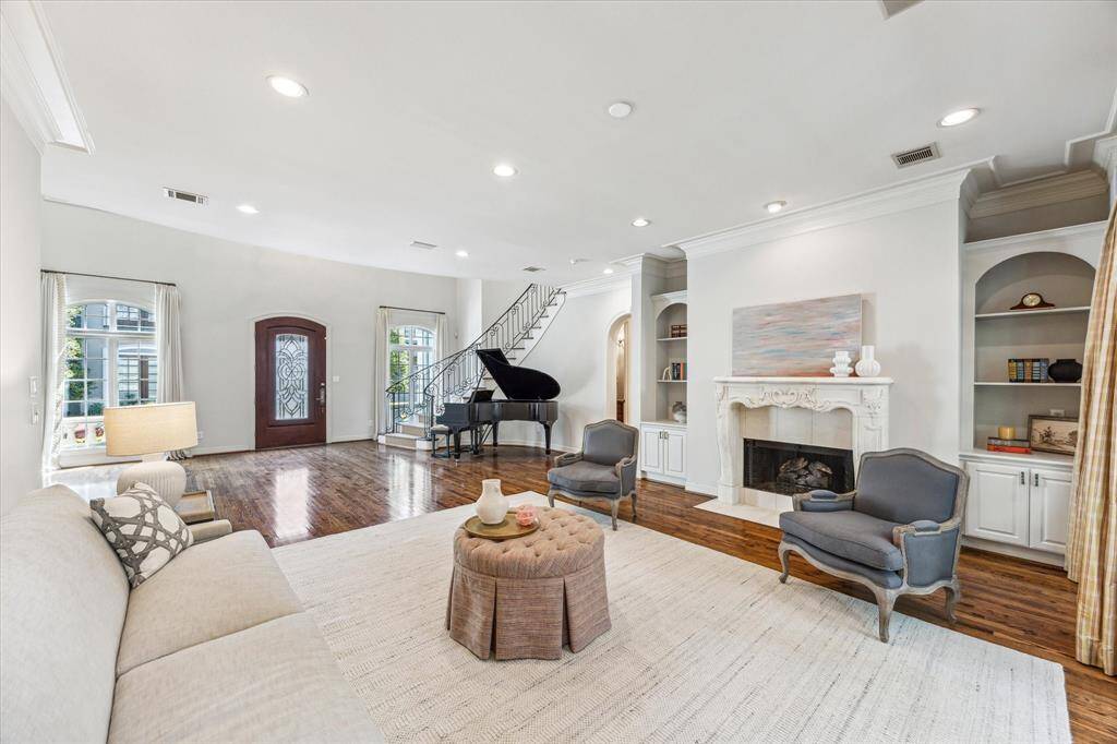 Here's another wonderful perspective of this delightful living room, showcasing its inviting ambiance, elegant decor, and the seamless flow of natural light through the expansive windows.
