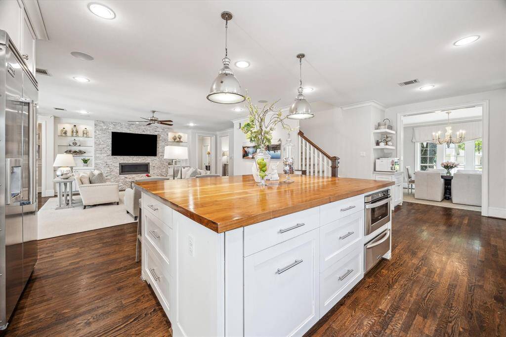 Indulge in a chef's dream kitchen with a versatile island featuring a Sharp microwave drawer, KitchenAid warming drawer, and tons of deep pots & pans drawer with soft-close.